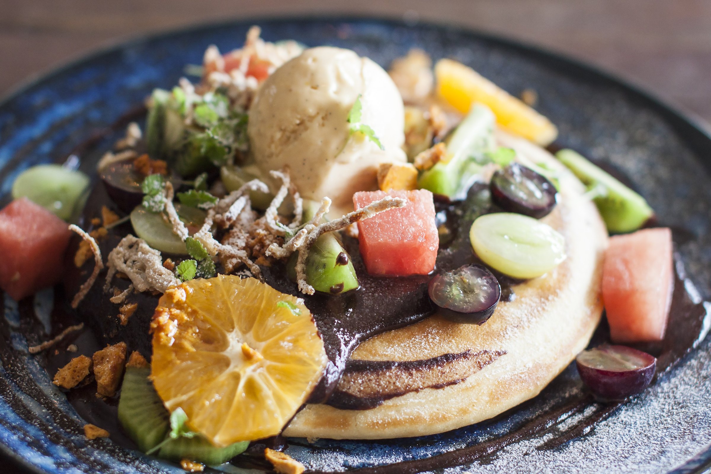 Pancake with fresh fruit, chocolate and ice cream